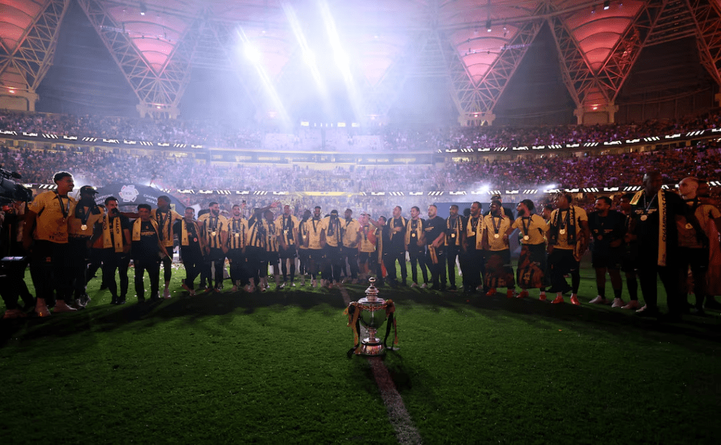 Al Ittihad players celebrating Saudi Pro League trophy victory