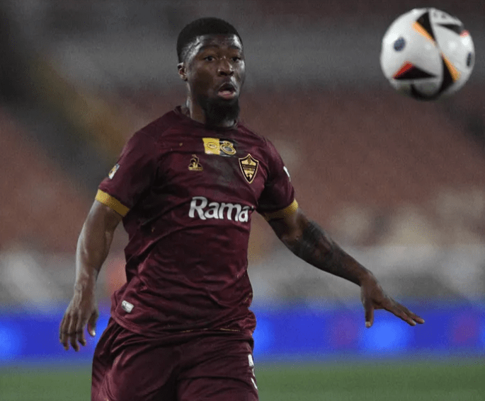 Stellenbosch FC left back Omega Mdaka in action during a match, showcasing his speed and energy on the left flank.