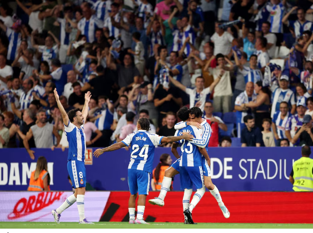 Espanyol players celebrate late winner against Atletico Madrid in LaLiga clash.
