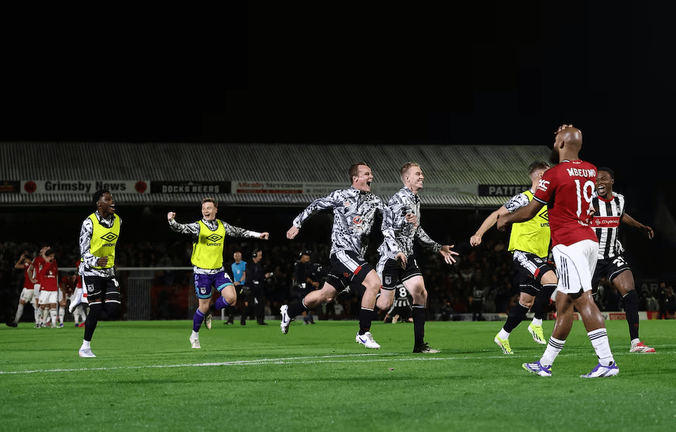 anchester United’s Bryan Mbeumo looks dejected after missing decisive penalty against Grimsby in Carabao Cup